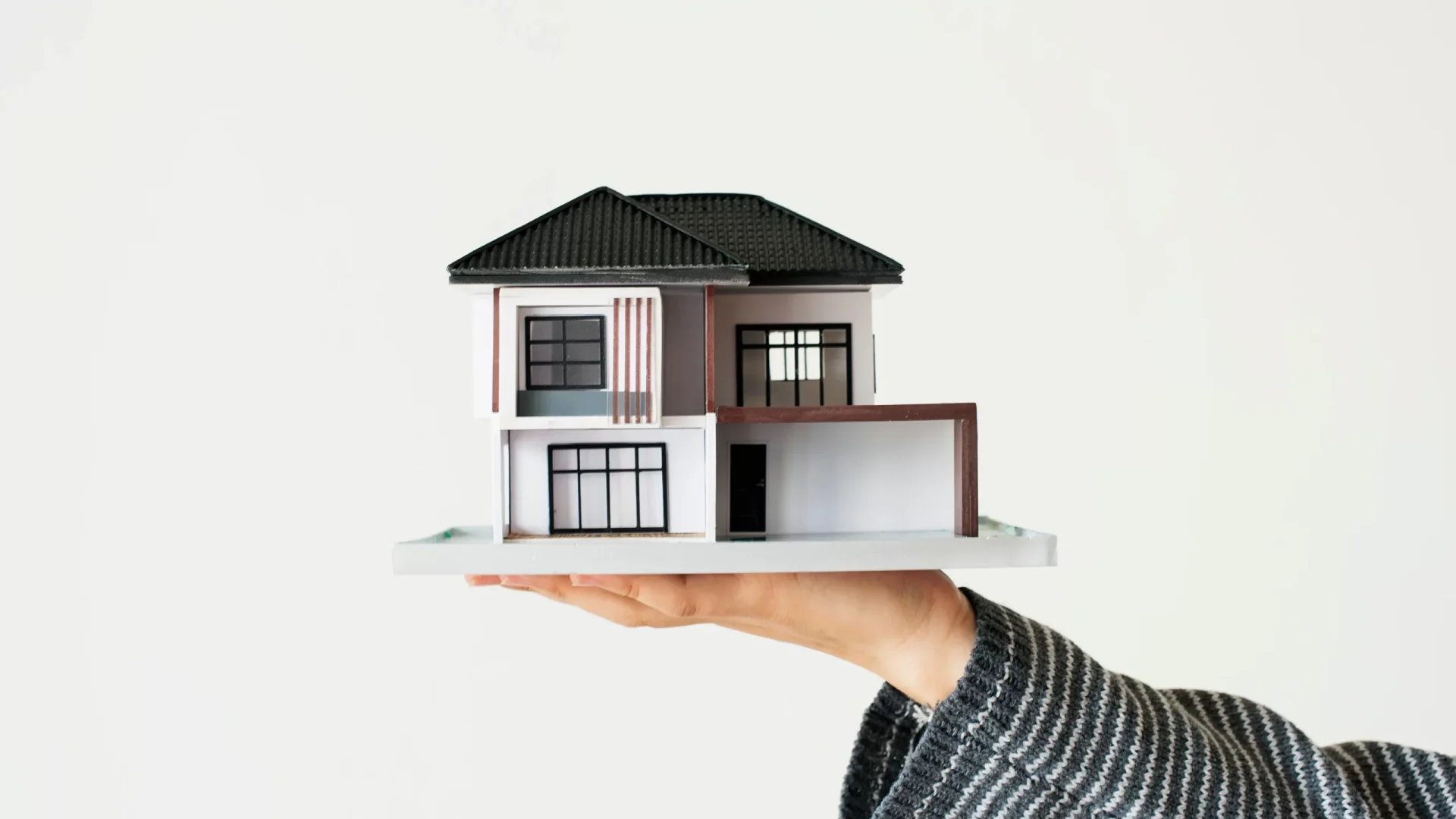 hand-presenting-model-house-home-loan-campaign